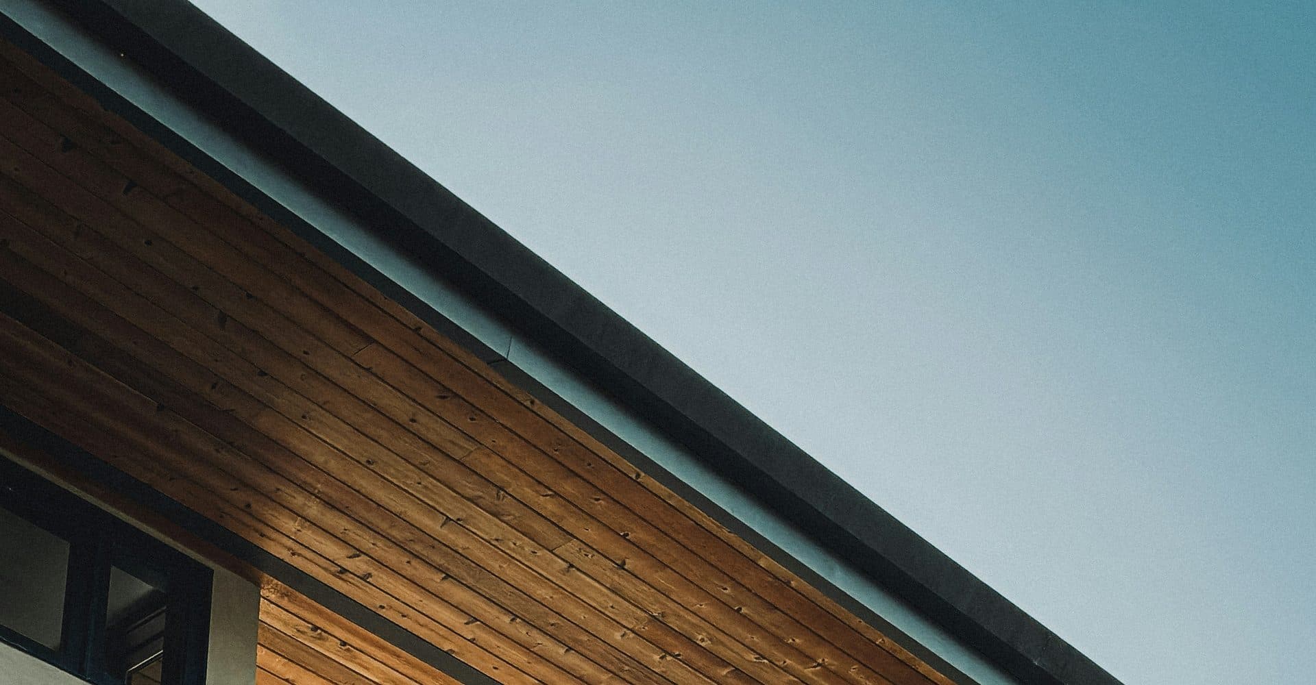 Curved wood tongue-and-groove ceiling with warm ambient lighting