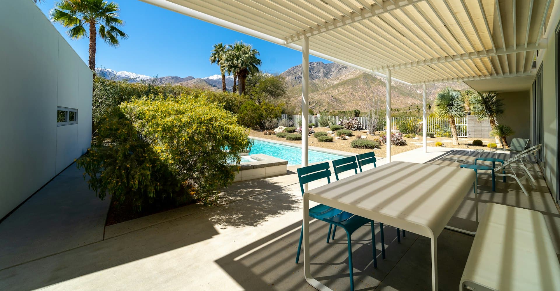 Modern outdoor patio with a wood-look insulated roof panel ceiling and pool